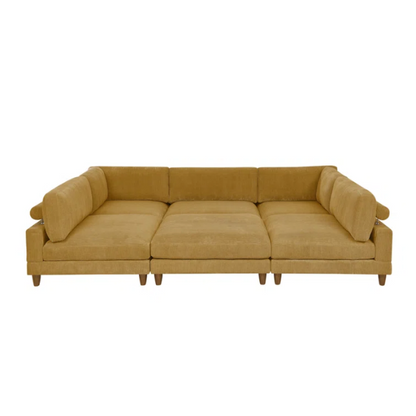 Modular mustard yellow corduroy sectional sofa with removable cushions, deep seating, and a matching ottoman — ideal for bold, spacious living room layouts.

