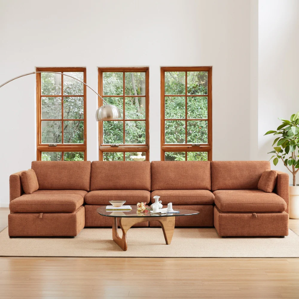 Terracotta six-piece modular sofa set featuring wide chenille-upholstered seats, two gas-lift storage ottomans, and reversible cushions — a bold, earthy centerpiece for modern or eclectic interiors.

