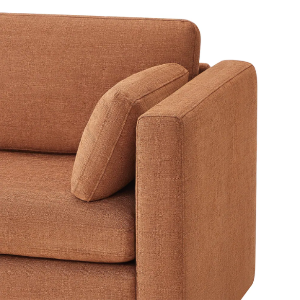 Terracotta six-piece modular sofa set featuring wide chenille-upholstered seats, two gas-lift storage ottomans, and reversible cushions — a bold, earthy centerpiece for modern or eclectic interiors.

