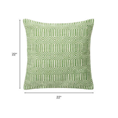 Green and cream geometric throw pillow on outdoor seating with modern patio decor

