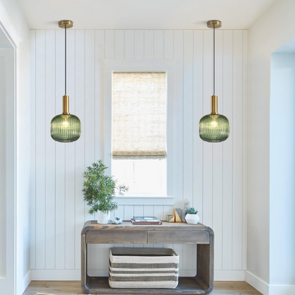 Green glass pendant light with gold accent finishes, modern ceiling fixture for kitchen, dining room, and living room.