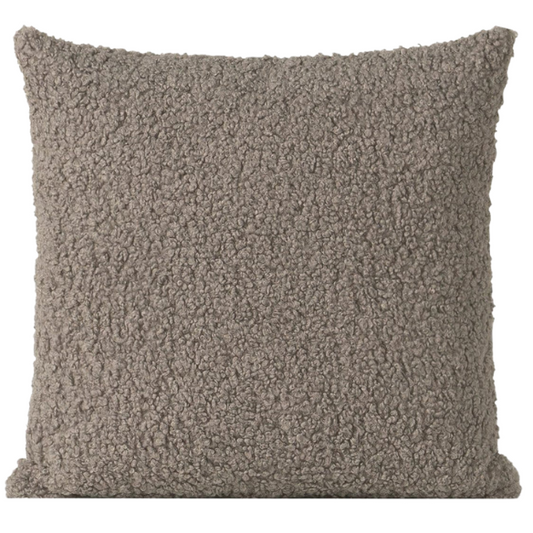 Grey bouclé throw pillow with soft looped texture, square accent pillow on a modern neutral-toned sofa

