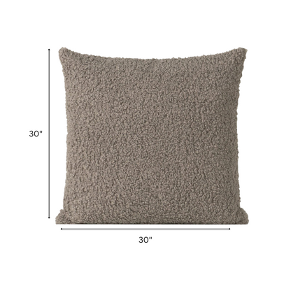 Grey bouclé throw pillow with soft looped texture, square accent pillow on a modern neutral-toned sofa

