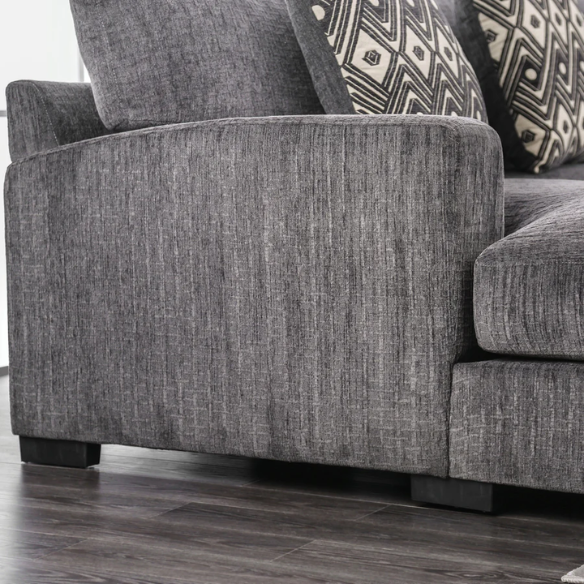 Modern grey chenille sectional sofa with chaise lounge, geometric accent pillows, and track arms in a contemporary living room setting