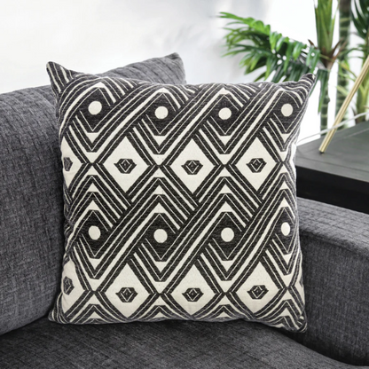 Modern grey chenille sectional sofa with chaise lounge, geometric accent pillows, and track arms in a contemporary living room setting