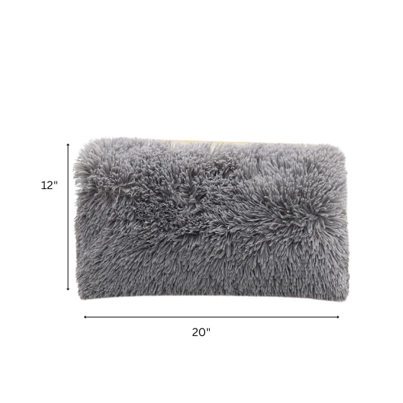 Set of two grey faux fur throw pillows with plush texture on a modern sofa

