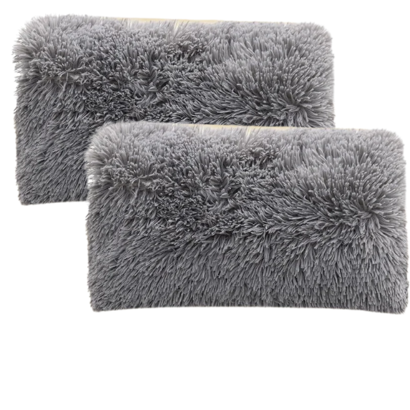 Set of two grey faux fur throw pillows with plush texture on a modern sofa

