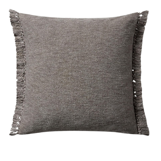 Grey cotton blend throw pillow with fringe, 22x22 square cushion featuring soft texture and hidden zipper, styled on a modern sofa for cozy, neutral decor.

