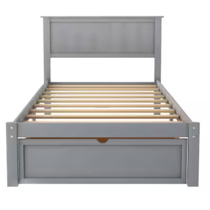 Grey twin platform bed made from solid pine wood with a rectangular headboard and a pull-out underbed storage drawer, featuring sturdy center support legs and a clean modern finish.

