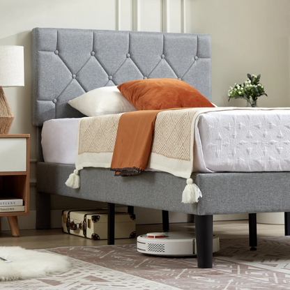 Grey upholstered twin platform bed frame with diamond-tufted linen headboard, sturdy metal construction, and center support legs, no box spring needed.

