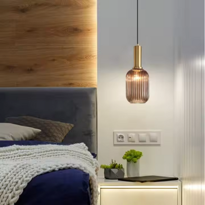 Industrial vintage pendant light with ribbed amber glass and brass finish for modern home decor.