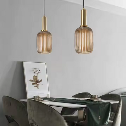 Industrial vintage pendant light with ribbed amber glass and brass finish for modern home decor.
