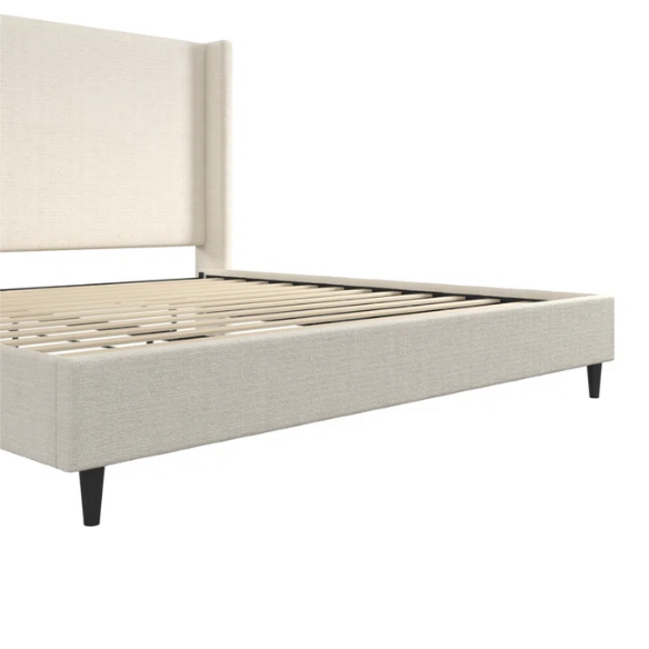 Ivory bouclé upholstered king-size platform bed with tall wingback headboard, wood slats, and no box spring required.

