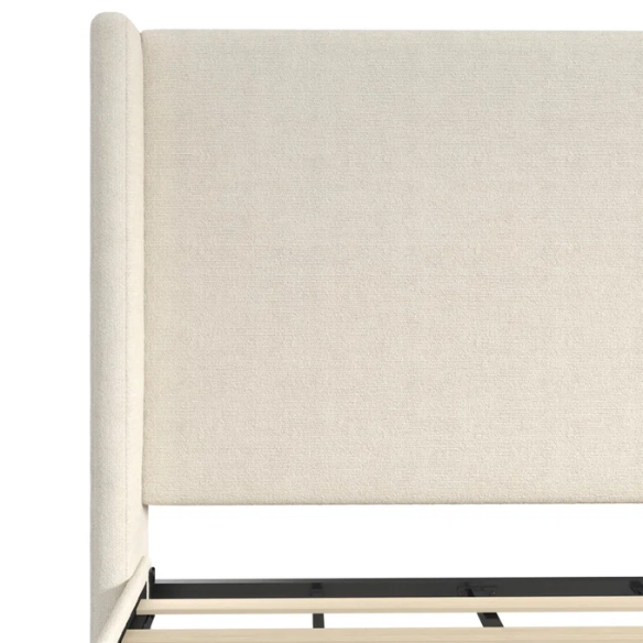 Ivory bouclé upholstered king-size platform bed with tall wingback headboard, wood slats, and no box spring required.

