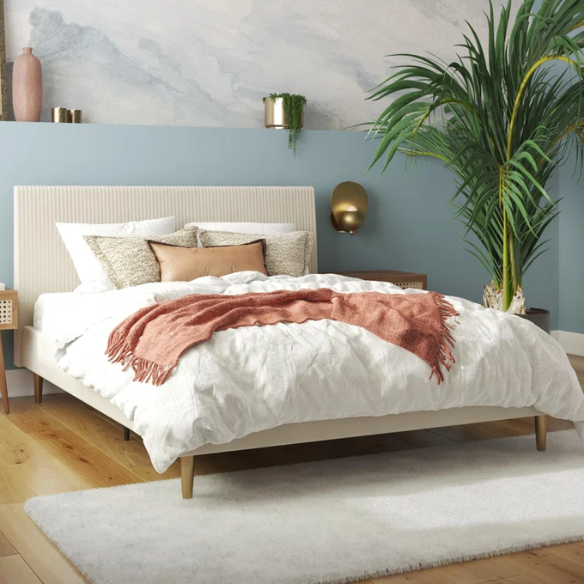 Ivory velvet king-size platform bed with upholstered headboard and footboard, no box spring required.

