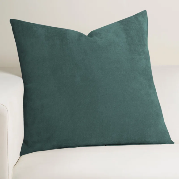 Juniper green crushed velvet throw pillow, 16x16 square with soft, reversible fabric and hidden zipper, styled on a cozy sofa for a sophisticated touch.


