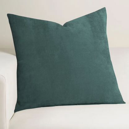 Juniper green crushed velvet throw pillow, 16x16 square with soft, reversible fabric and hidden zipper, styled on a cozy sofa for a sophisticated touch.

