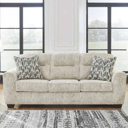 Light beige 3-seater sofa with plush cushions, accent pillows, and dark tri-block legs, ideal for modern living rooms.

