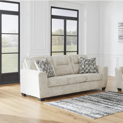 Light beige 3-seater sofa with plush cushions, accent pillows, and dark tri-block legs, ideal for modern living rooms.

