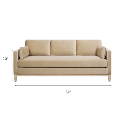 Light camel velvet 3-seater sofa with feather-down cushions, track arms, and solid wood legs, ideal for modern and transitional spaces.

