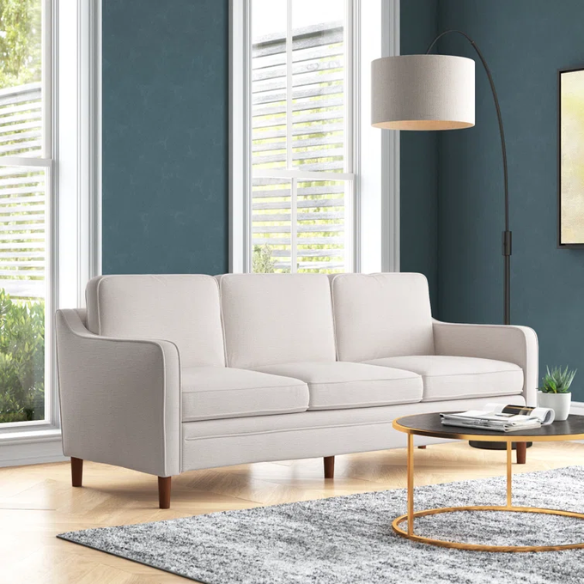 Light grey chenille upholstered sofa with curved track arms, foam-filled cushions, and brown tapered wood legs in a modern mid-century design.