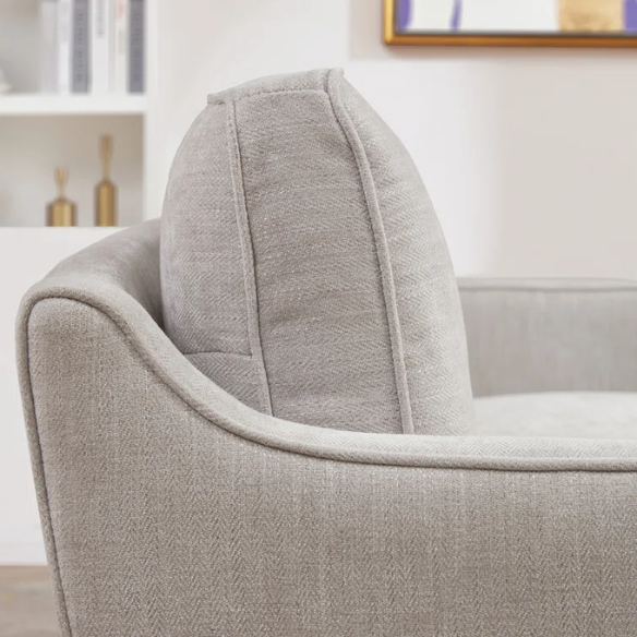 Light grey chenille upholstered sofa with curved track arms, foam-filled cushions, and brown tapered wood legs in a modern mid-century design.