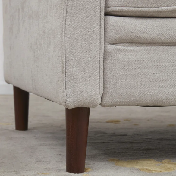 Light grey chenille upholstered sofa with curved track arms, foam-filled cushions, and brown tapered wood legs in a modern mid-century design.