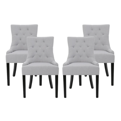 Set of four light grey upholstered dining chairs with diamond tufted backs, armless design, sloped armrests, and espresso brown wood legs.

