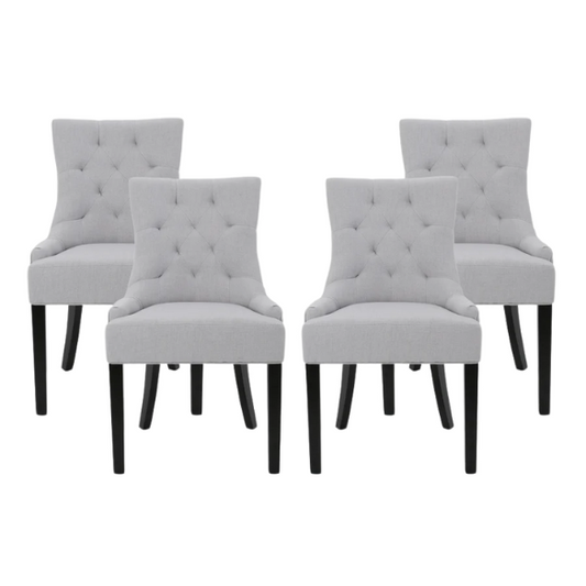 Set of four light grey upholstered dining chairs with diamond tufted backs, armless design, sloped armrests, and espresso brown wood legs.

