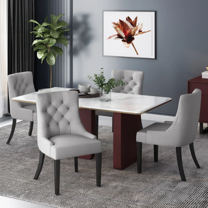 Set of four light grey upholstered dining chairs with diamond tufted backs, armless design, sloped armrests, and espresso brown wood legs.

