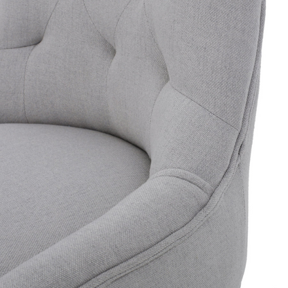 Set of four light grey upholstered dining chairs with diamond tufted backs, armless design, sloped armrests, and espresso brown wood legs.

