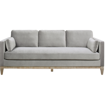 Light grey velvet 3-seater sofa with feather-down cushions, track arms, and natural wood legs, designed for modern and transitional spaces.

