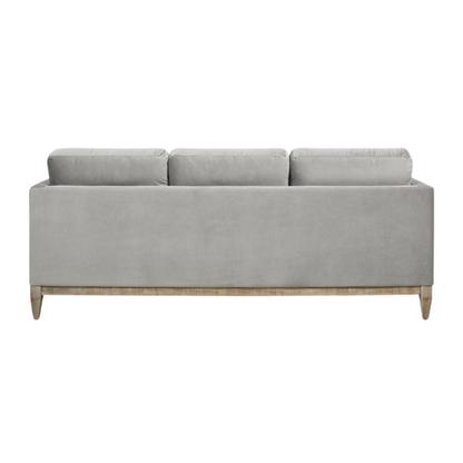 Light grey velvet 3-seater sofa with feather-down cushions, track arms, and natural wood legs, designed for modern and transitional spaces.

