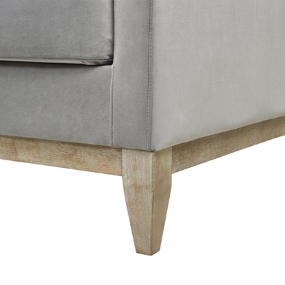 Light grey velvet 3-seater sofa with feather-down cushions, track arms, and natural wood legs, designed for modern and transitional spaces.


