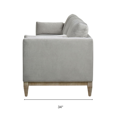 Light grey velvet 3-seater sofa with feather-down cushions, track arms, and natural wood legs, designed for modern and transitional spaces.

