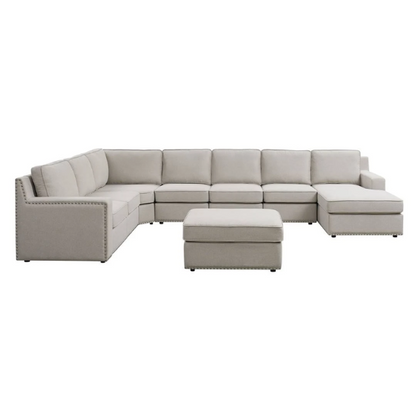 Spacious light taupe U-shaped sectional sofa with reversible configuration, removable cushions, nailhead trim, and matching ottoman—seats up to 8.

