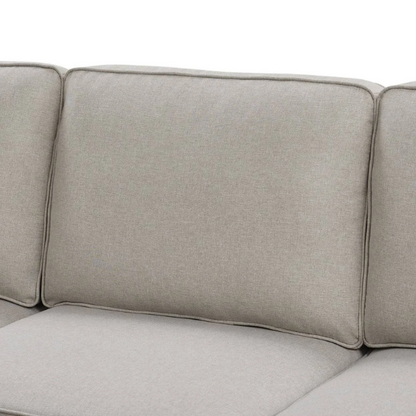 Spacious light taupe U-shaped sectional sofa with reversible configuration, removable cushions, nailhead trim, and matching ottoman—seats up to 8.

