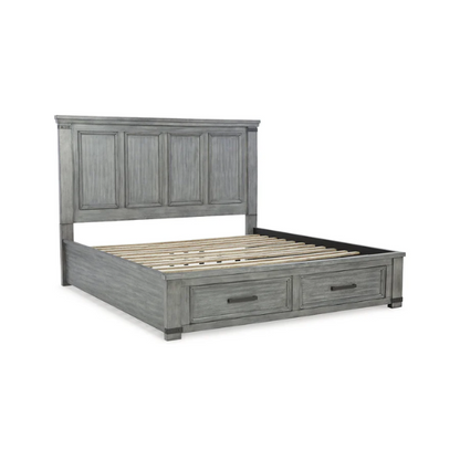 King-size storage bed in light weathered gray finish with tall panel headboard, footboard drawers, and dark bronze hardware accents

