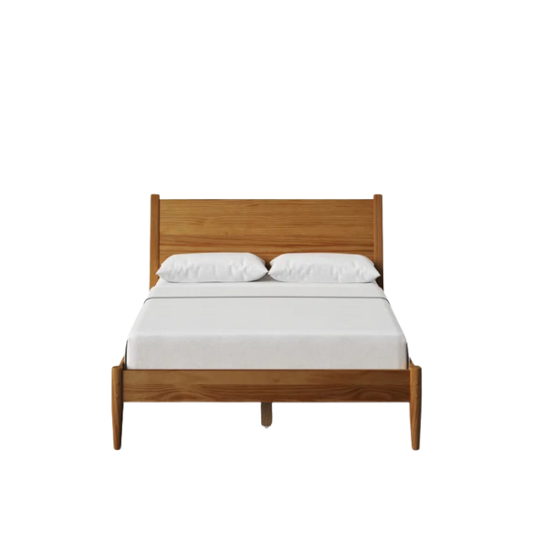 Mid-century modern full-size solid wood platform bed in medium light brown with rectangular headboard and tapered legs