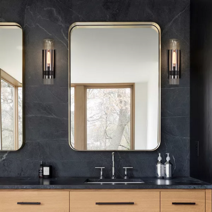 Modern black wall sconce with cylindrical clear glass shade – contemporary uplight fixture for bathrooms, hallways, or bedrooms