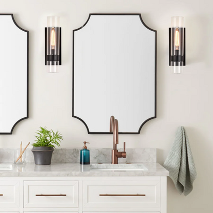 Modern black wall sconce with cylindrical clear glass shade – contemporary uplight fixture for bathrooms, hallways, or bedrooms