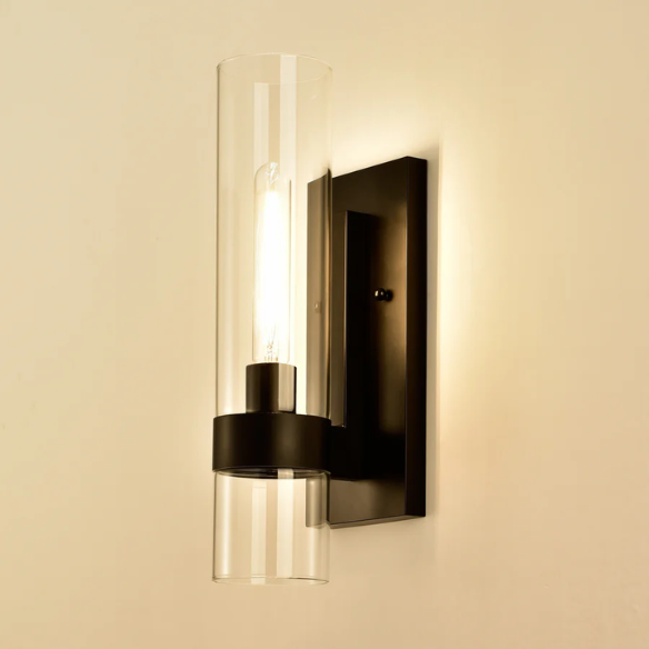 Modern black wall sconce with cylindrical clear glass shade – contemporary uplight fixture for bathrooms, hallways, or bedrooms

