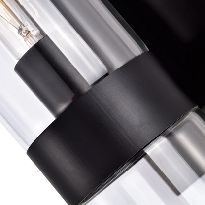 Modern black wall sconce with cylindrical clear glass shade – contemporary uplight fixture for bathrooms, hallways, or bedrooms

