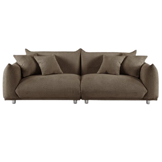 Modern camel upholstered sofa with deep seating and chrome-finished legs, featuring 4 matching accent pillows, ideal for stylish living rooms.