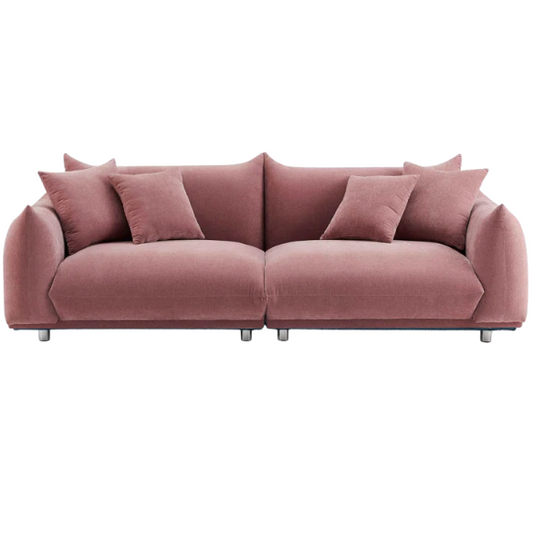 Modern dusty rose upholstered sofa with deep seating and chrome-finished legs, featuring four matching accent pillows—ideal for soft, stylish living spaces.