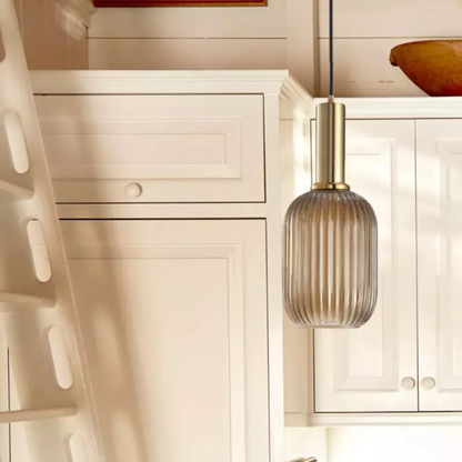 Modern grey glass pendant light with gold finish, ideal for contemporary and industrial interiors.