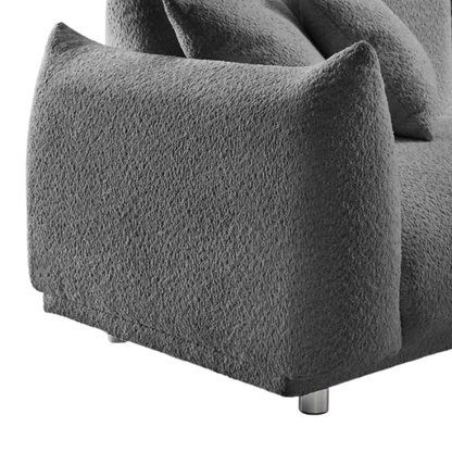 Modern 88.9-inch grey upholstered sofa with deep seat, rounded arms, chrome legs, and four matching accent pillows – ideal for contemporary living rooms or apartments.

