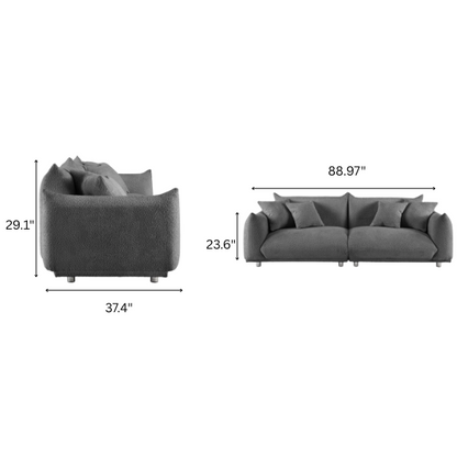 Modern 88.9-inch grey upholstered sofa with deep seat, rounded arms, chrome legs, and four matching accent pillows – ideal for contemporary living rooms or apartments.

