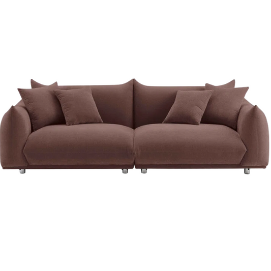 Modern muted brown upholstered sofa with deep seating and chrome-finished legs, featuring four matching accent pillows—ideal for warm, modern interiors.