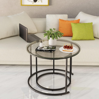 Modern round nesting coffee tables with black glass top and black metal legs